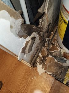 water heater closet wall water damage closeup.jpeg Plumbers
